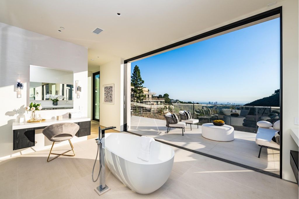 The Bel Air Home is an immaculately designed contemporary masterpiece with explosive canyon, ocean, and city views now available for sale. This home located at 1037 Stradella Rd, Los Angeles, California