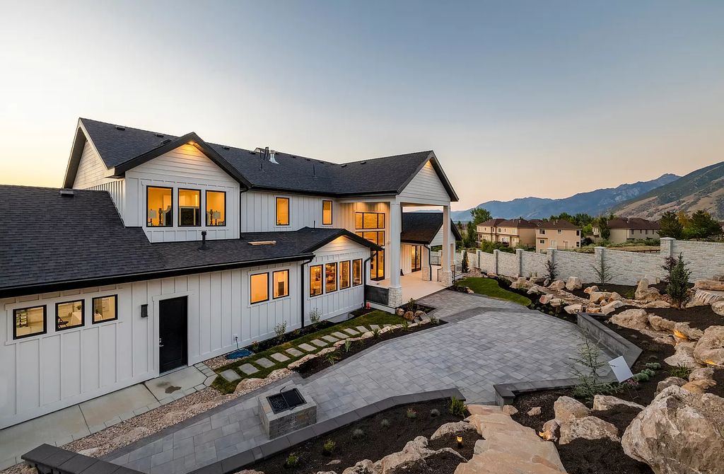 The Modern Farmhouse in Utah is a beautiful newly constructed 2-Story home fully landscaped with a majestic waterfall now available for sale. This home located at 14731 S Aulani Cv E, Draper, Utah; offering 7 bedrooms and 8 bathrooms with over 9,500 square feet of living spaces.