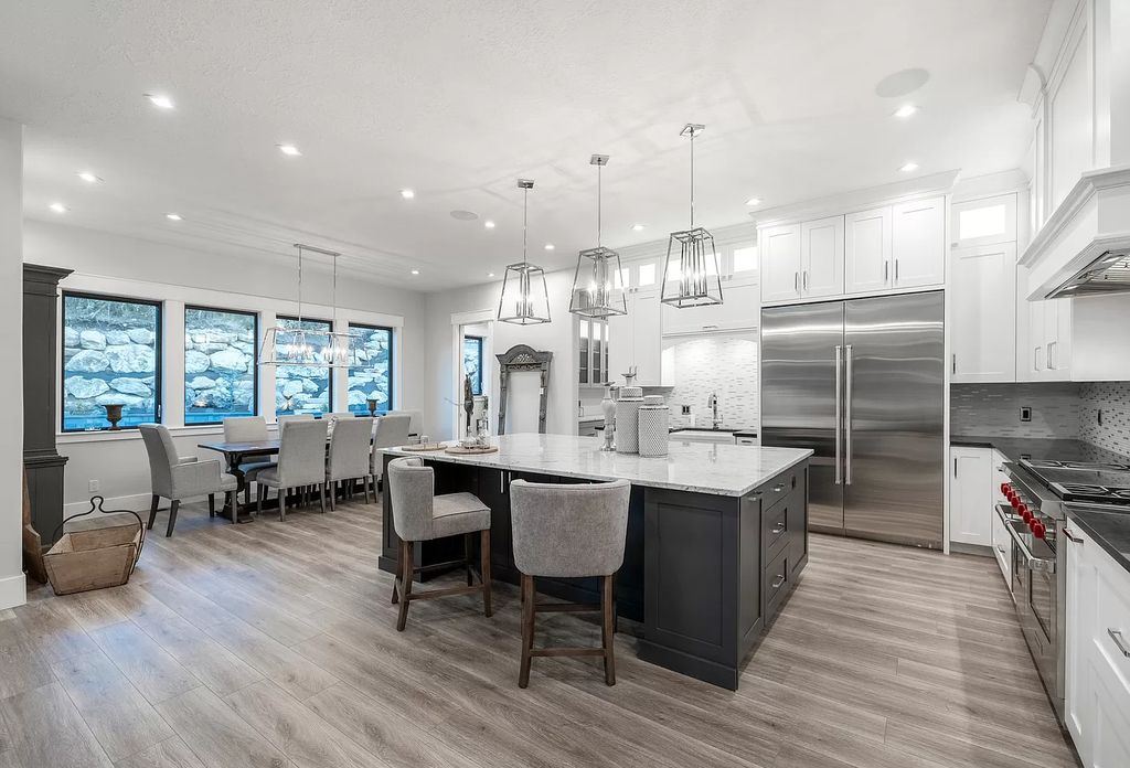 The Modern Farmhouse in Utah is a beautiful newly constructed 2-Story home fully landscaped with a majestic waterfall now available for sale. This home located at 14731 S Aulani Cv E, Draper, Utah; offering 7 bedrooms and 8 bathrooms with over 9,500 square feet of living spaces.