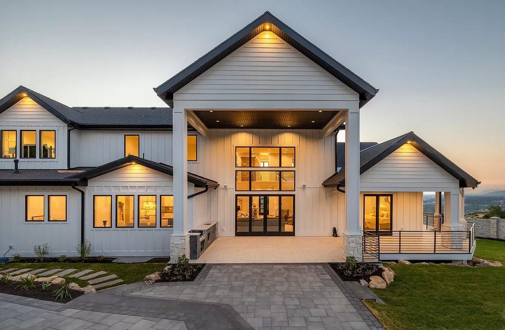 The Modern Farmhouse in Utah is a beautiful newly constructed 2-Story home fully landscaped with a majestic waterfall now available for sale. This home located at 14731 S Aulani Cv E, Draper, Utah; offering 7 bedrooms and 8 bathrooms with over 9,500 square feet of living spaces.