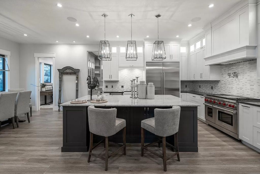 The Modern Farmhouse in Utah is a beautiful newly constructed 2-Story home fully landscaped with a majestic waterfall now available for sale. This home located at 14731 S Aulani Cv E, Draper, Utah; offering 7 bedrooms and 8 bathrooms with over 9,500 square feet of living spaces.