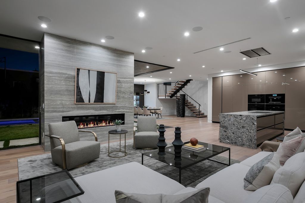 The Modern Home in Los Angeles is an exquisite warn new construction residence offers an array of earthy elements now available for sale. This home located at 5554 Green Oak Dr, Los Angeles, California