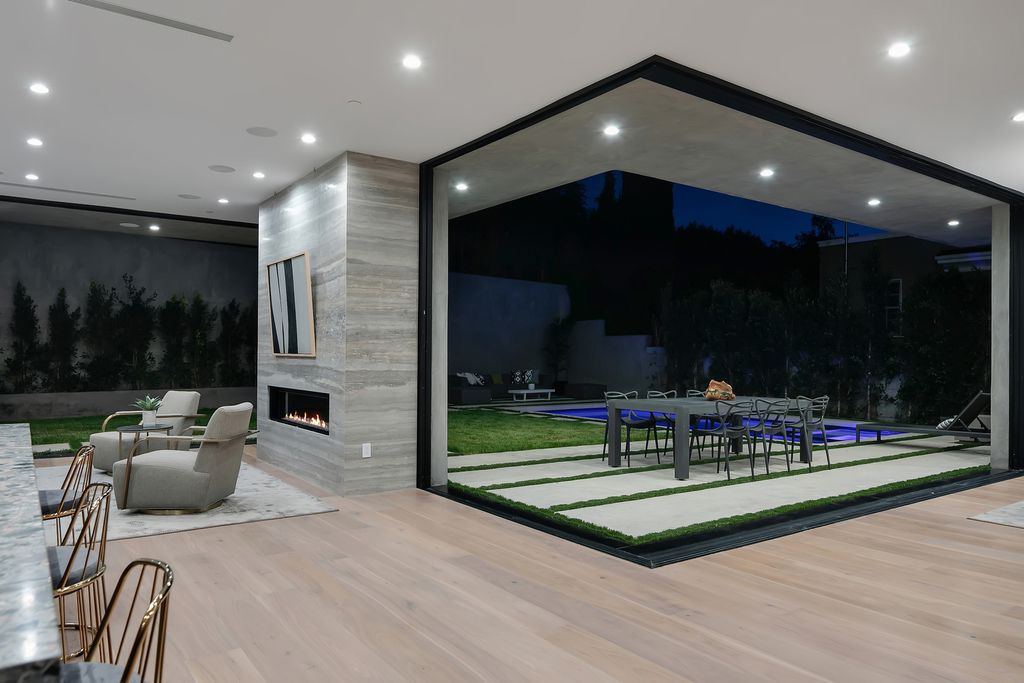 The Modern Home in Los Angeles is an exquisite warn new construction residence offers an array of earthy elements now available for sale. This home located at 5554 Green Oak Dr, Los Angeles, California