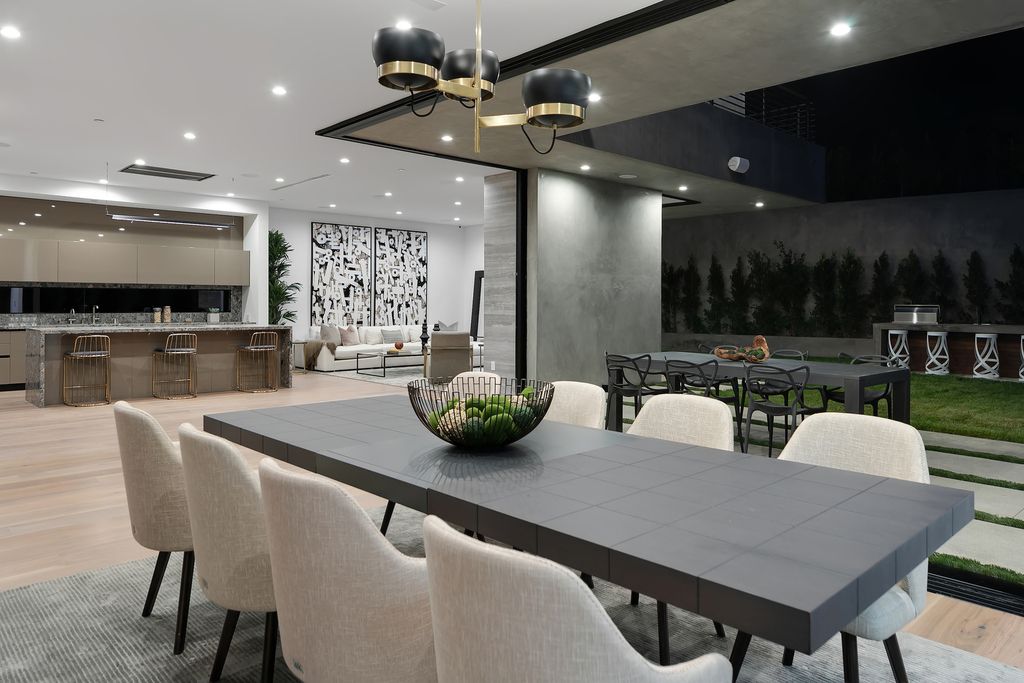 The Modern Home in Los Angeles is an exquisite warn new construction residence offers an array of earthy elements now available for sale. This home located at 5554 Green Oak Dr, Los Angeles, California