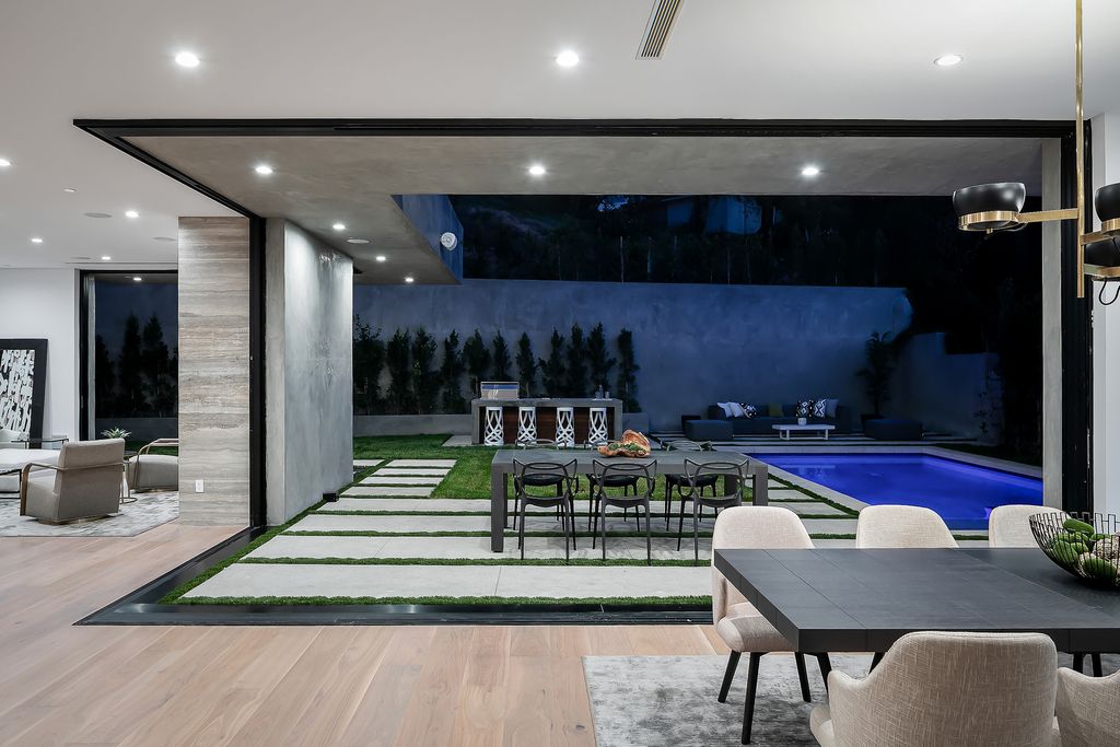 The Modern Home in Los Angeles is an exquisite warn new construction residence offers an array of earthy elements now available for sale. This home located at 5554 Green Oak Dr, Los Angeles, California