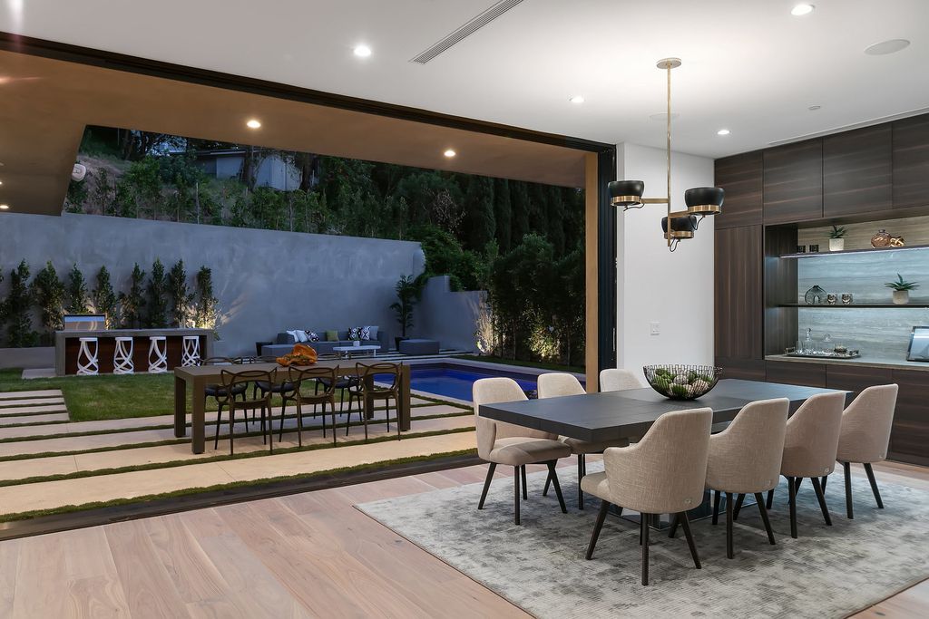 The Modern Home in Los Angeles is an exquisite warn new construction residence offers an array of earthy elements now available for sale. This home located at 5554 Green Oak Dr, Los Angeles, California