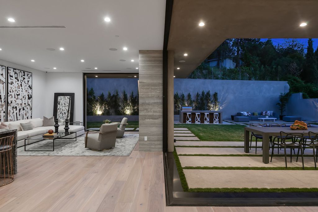 The Modern Home in Los Angeles is an exquisite warn new construction residence offers an array of earthy elements now available for sale. This home located at 5554 Green Oak Dr, Los Angeles, California