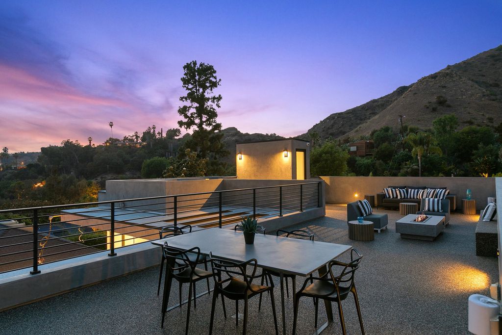 The Modern Home in Los Angeles is an exquisite warn new construction residence offers an array of earthy elements now available for sale. This home located at 5554 Green Oak Dr, Los Angeles, California