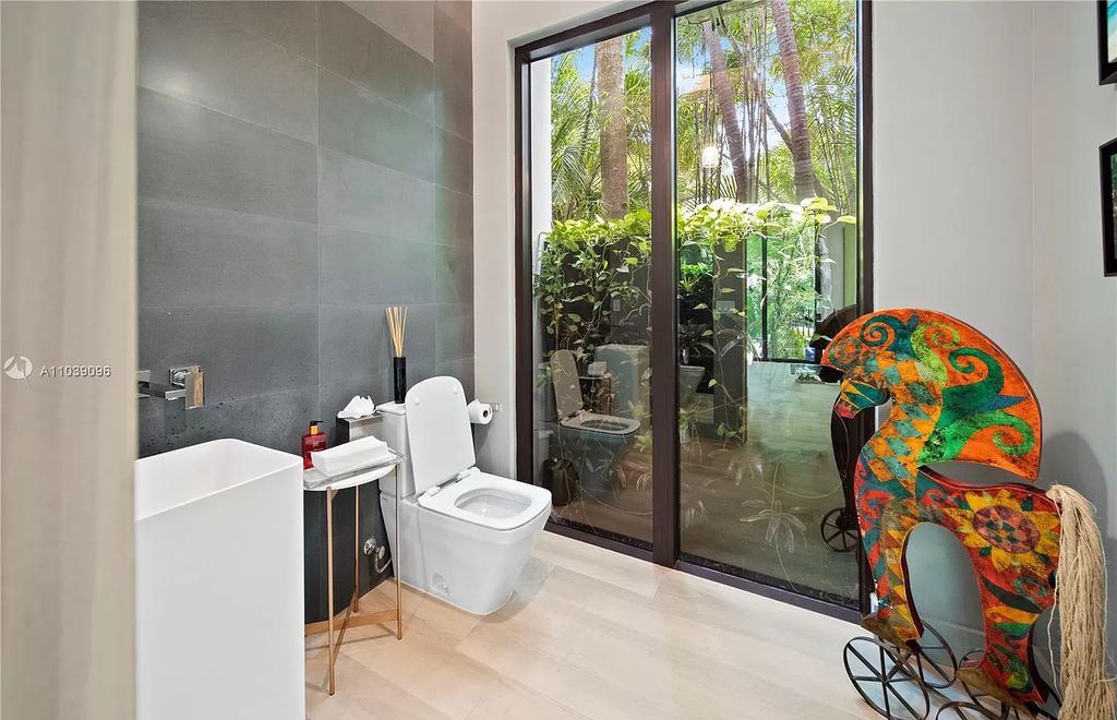 The Home in Miami is a Tropical Modern property located in the heart of Coconut Grove surrounded by lush gardens now available for sale. This home located at 3525 Royal Palm Ave, Miami, Florida