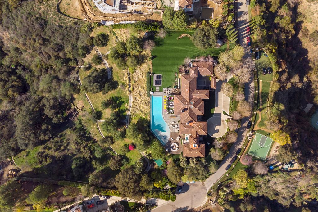 The Beverly Hills Mansion is a World class compound with stunning panoramic views set in guard gated Bella Vista Estates now available for sale. This home located at 2505 Summitridge Dr, Beverly Hills, California