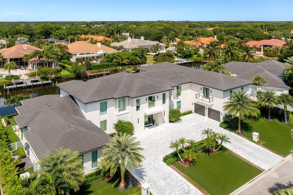 The Home in Palm Beach Gardens is a waterfront contemporary estate located in Frenchman's Creek with 155 feet of deep waterfront now available for sale. This home located at 13843 Le Bateau Isle, Palm Beach Gardens, Florida