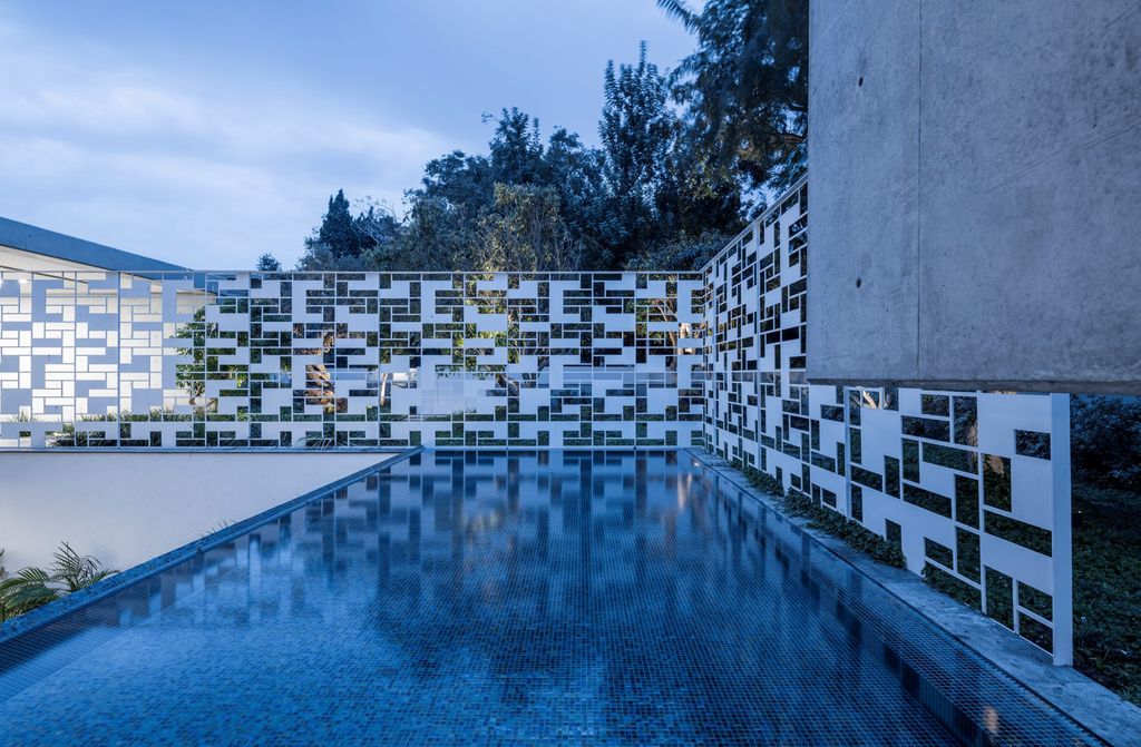 AB House with Grid-like Perforated Screens Features by Pitsou Kedem