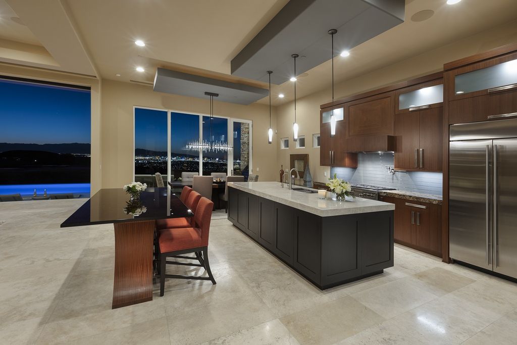 The Home in Henderson is a smart custom estate with sweeping strip, city, golf & mountain views with high quality finishes now available for sale. This home located at 675 Scenic Rim Dr, Henderson, Nevada