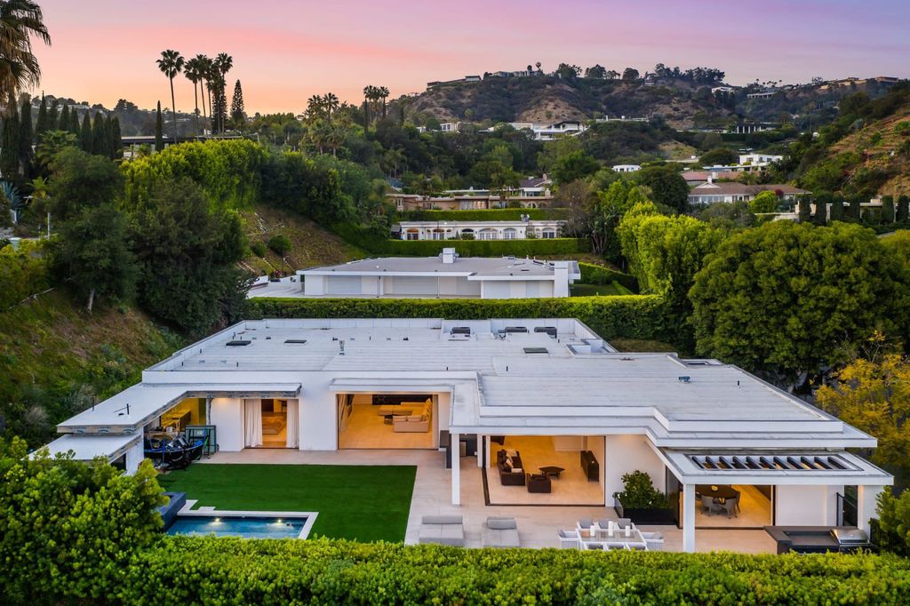 The Contemporary Home in Beverly Hills with panoramic views is built with soaring ceilings, clean lines, and sleek intricacies now available for sale. This home located at 1041 N Hillcrest Rd, Beverly Hills, California