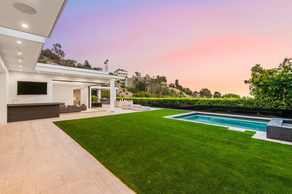 The Contemporary Home in Beverly Hills with panoramic views is built with soaring ceilings, clean lines, and sleek intricacies now available for sale. This home located at 1041 N Hillcrest Rd, Beverly Hills, California