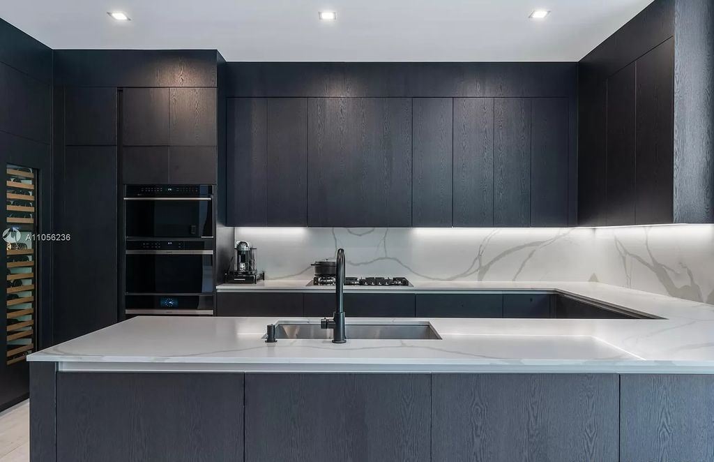 By using a monochromatic color scheme, you may create a classy and timeless kitchen. For the cabinets, countertops, and backsplash, use several tones of dark gray or black. To create depth and aesthetic intrigue to the area, use varied textures, such as matte and glossy finishes.