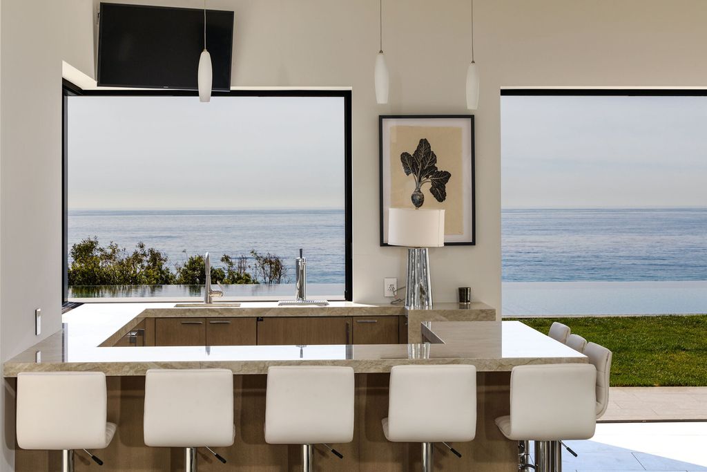 The Villa in Malibu is a sexy single-story has soaring ceilings, French oak wood and sea stone floors, and stone, wood finishes now available for sale. This home located at 11902 Ellice St, Malibu, California