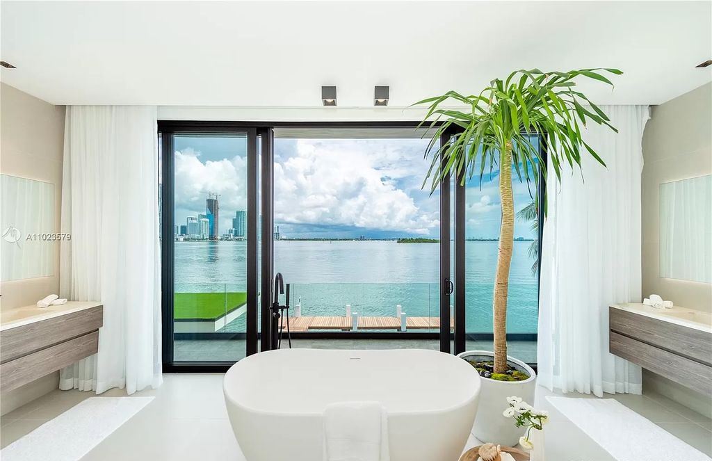 The Waterfront Home in Miami Beach is a brand new contemporary estate offers stunning water and Miami Skyline views now available for sale. This home located at 831 N Venetian Dr, Miami Beach, Florida
