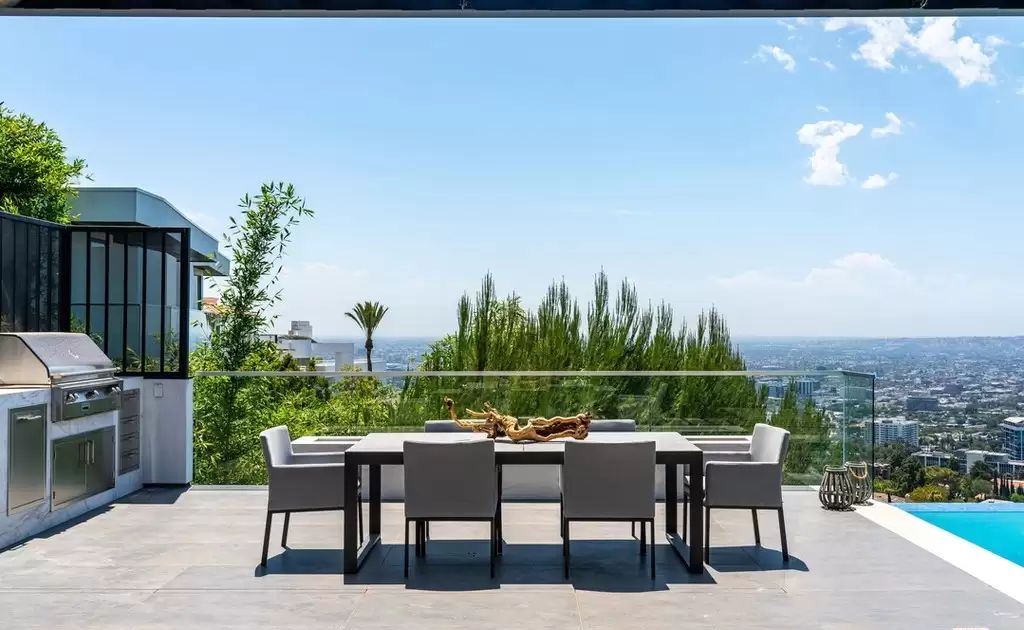 The Home in Hollywood Hills is a brand new contemporary masterpiece with unparalleled finishes and museum-quality materials now available for sale. This home located at 9410 Sierra Mar Pl, Los Angeles, California