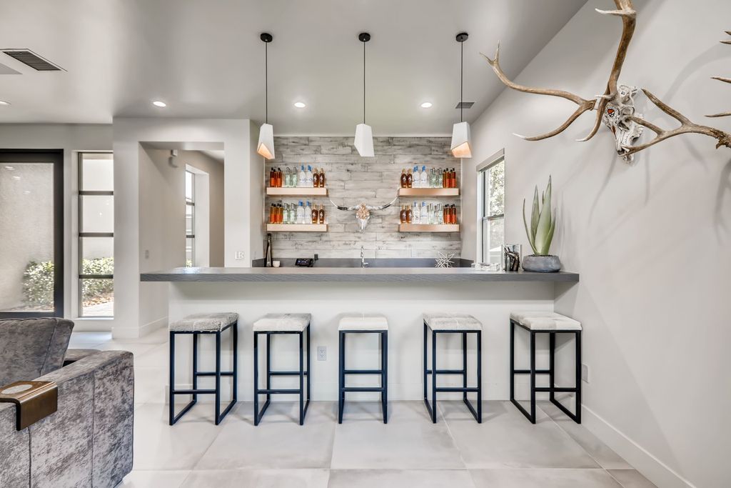 To ensure that your industrial kitchen island fits the overall style of the room, consider using reclaimed wood or metal for the base of the island. This will add an additional industrial touch that will tie the island into the rest of the design. You could also choose to incorporate other industrial elements into the island, such as metal accents or a concrete countertop, for a truly cohesive look.