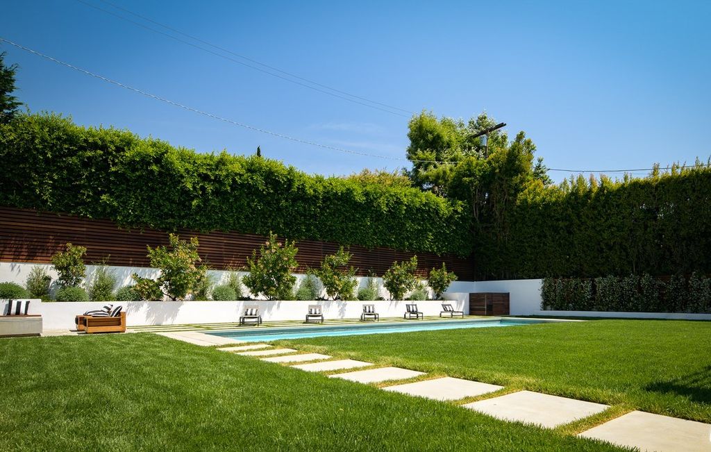The Brentwood Modern Farmhouse is a stunning newly built property with the finest materials and an amazing backyard oasis now available for sale. This home located at 12825 San Vicente Blvd, Los Angeles, California