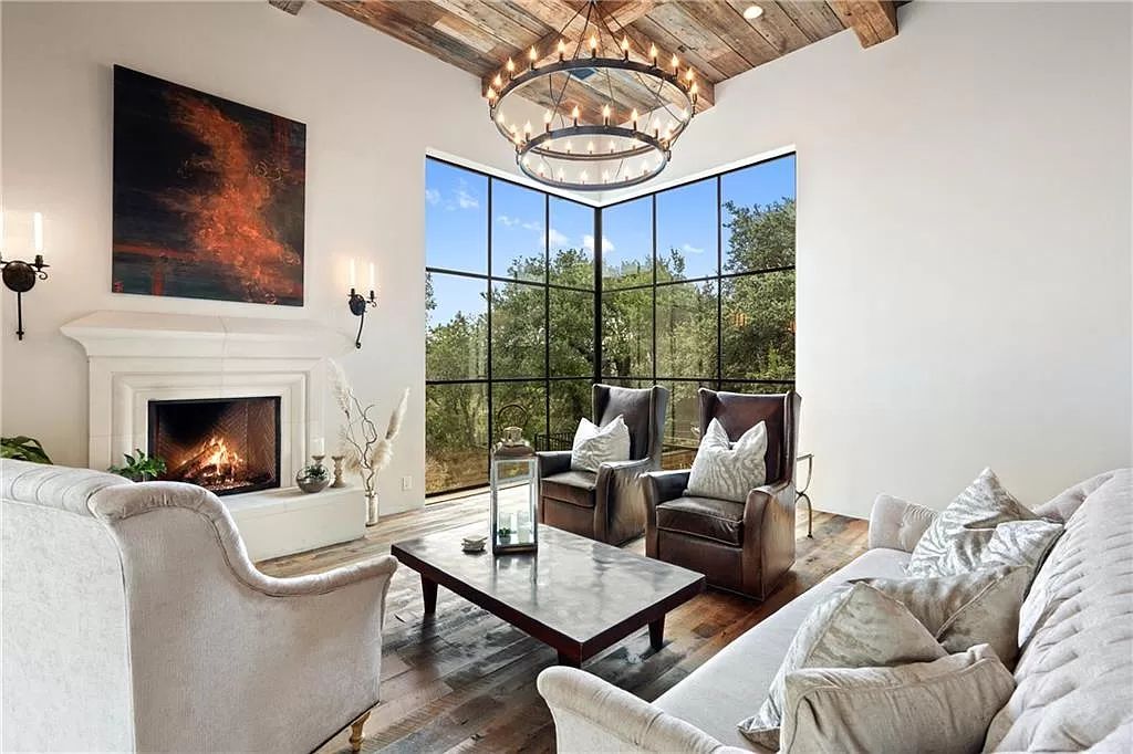 idyllic, rural, and cool the tranquil hues of blue, the charming rusticness of wood, and the contemporary vibe of the white, spotless walls and wood floors. The exposed wood beams emphasize the elegance of the area, while the sofa and chair combination keeps things intriguing.