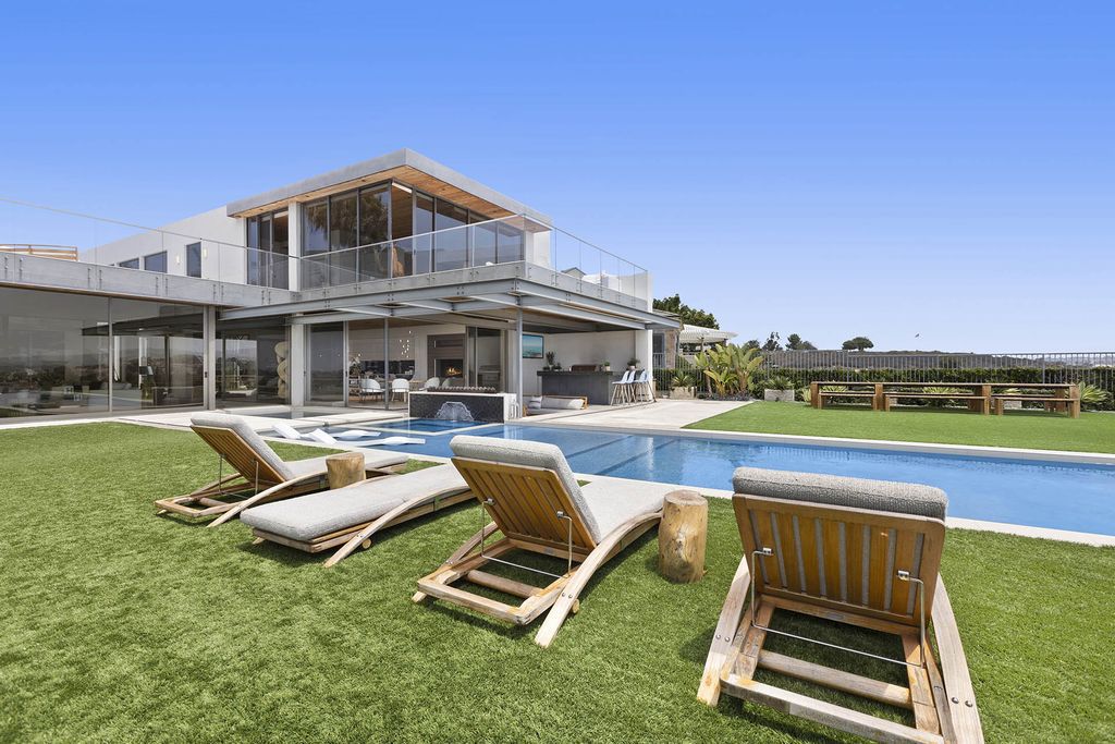 The Home in Newport Beach is a Stunning modern estate boasts unobstructed panoramic ocean, harbor, and city light views now available for sale. This home located at 104 Kings Pl, Newport Beach, California