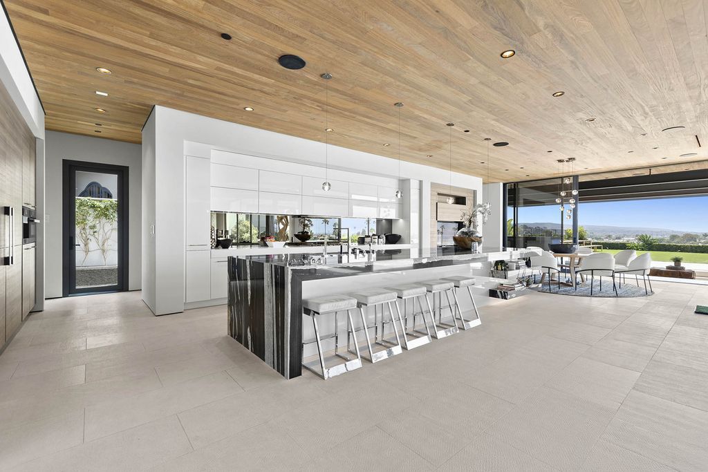 The Home in Newport Beach is a Stunning modern estate boasts unobstructed panoramic ocean, harbor, and city light views now available for sale. This home located at 104 Kings Pl, Newport Beach, California