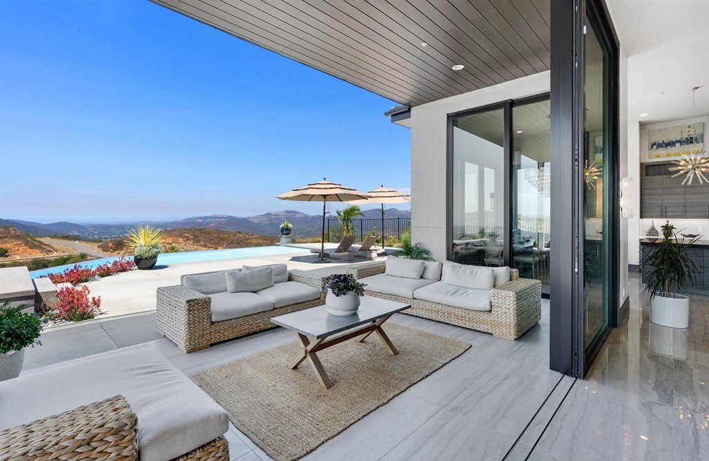 The Rancho Santa Fe Home is a private modern estate with breathtaking views of the ocean, canyons, and mountains in the community of Cielo now available for sale. This home located at 8370 Via Rancho Cielo, Rancho Santa Fe, California