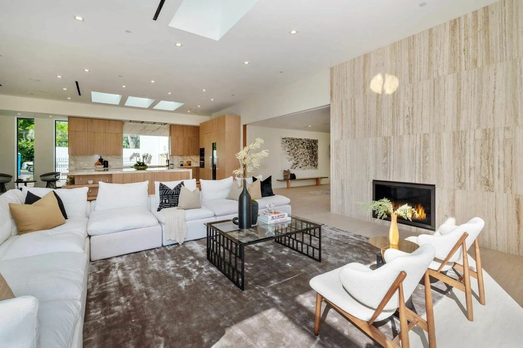 The Home in Beverly Hills is a captivating reimagined single-story sanctuary, situated behind private gates now available for sale. This home located at 410 Doheny Rd, Beverly Hills, California