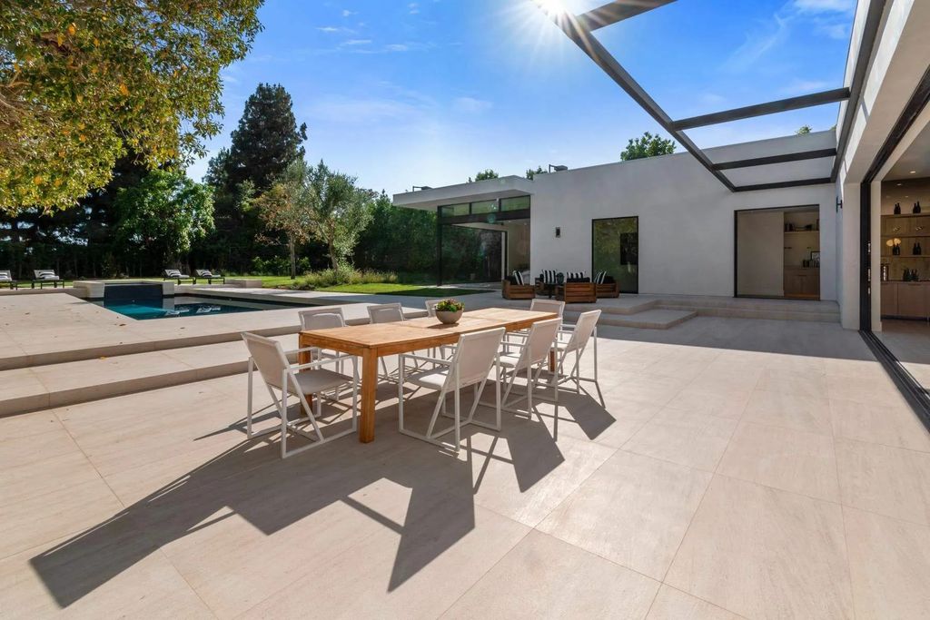 The Home in Beverly Hills is a captivating reimagined single-story sanctuary, situated behind private gates now available for sale. This home located at 410 Doheny Rd, Beverly Hills, California