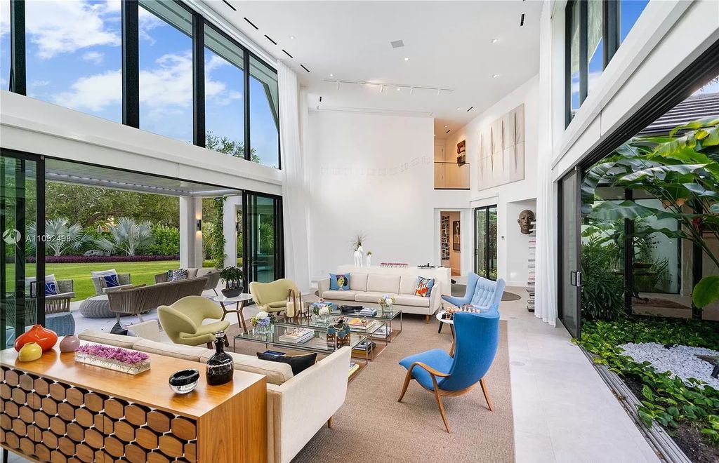 The Home in Miami is a true one of a kind two story estate nested on a corner lot surrounded by lush tropical gardens now available for sale. This home located at 450 Como Ave, Miami, Florida