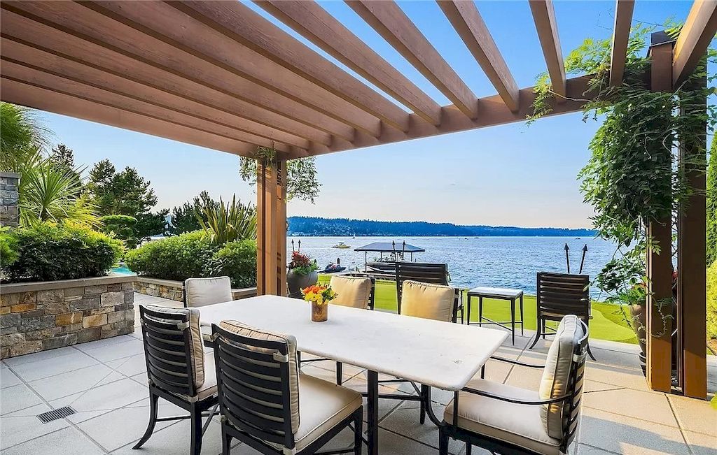 The Lakefront House in Washington features lush mature landscaping, sculptured gardens, and all day vistas now available for sale. This home is located at 18110 SE 41st Ln, Bellevue, Washington