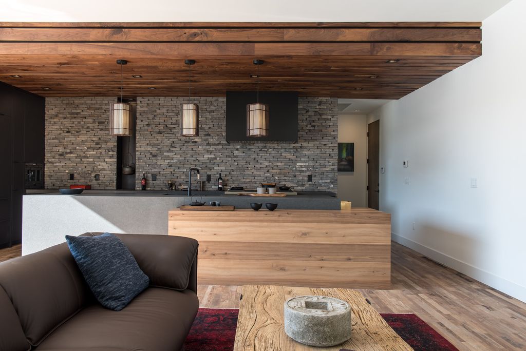With a basic and modern grey sofa and white painted walls, the timber ceiling breaks up the brown backdrop. The wood floor also adds warmth and character without being overpowering. 