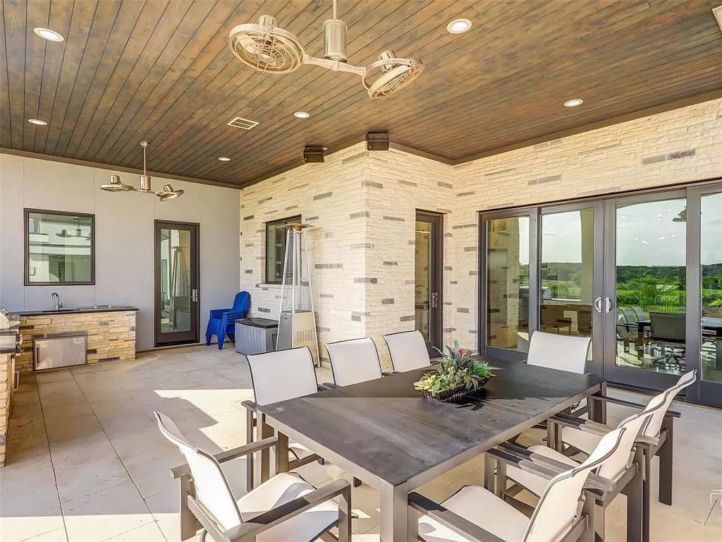 The Texas Modern Home is a light and bright home is designed for entertaining with soaring 2 story ceiling & floating staircase now available for sale. This home located at 8605 Amen Cor, Flower Mound, Texas