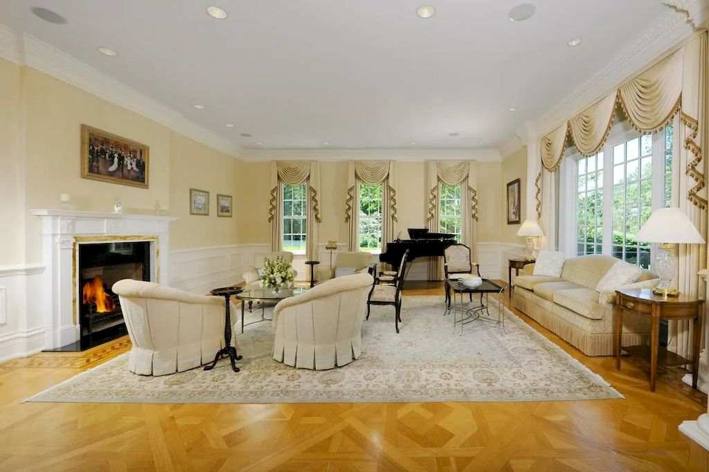 A soft beige with wavy designs for the drapes, or a Chesterfield-style sofa set, and a flying angel pattern rug fill the living room space. The soft velvet rug is draped all over the living room floor, bringing warmth, closeness, and harmony with the fireplace and the sitting arrangement of the appealing chairs. The entire place exudes harmony and intimacy.