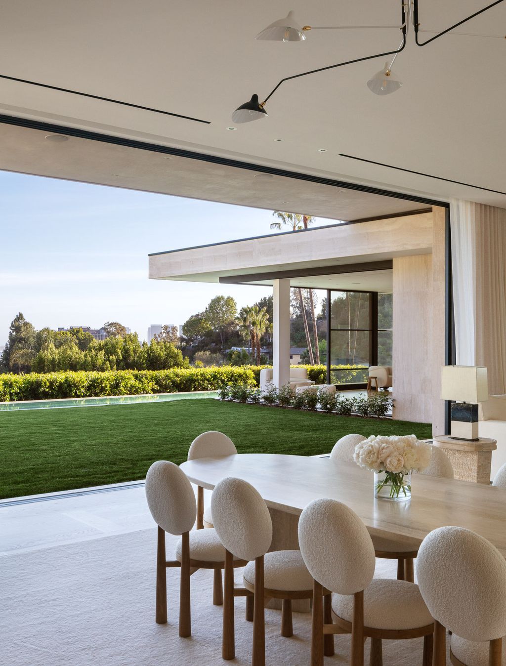 The Modern Mansion in Los Angeles is a warm sophisticated modern home nestled on an acre of land surrounded by lush landscape overlooking LA city now available for sale.