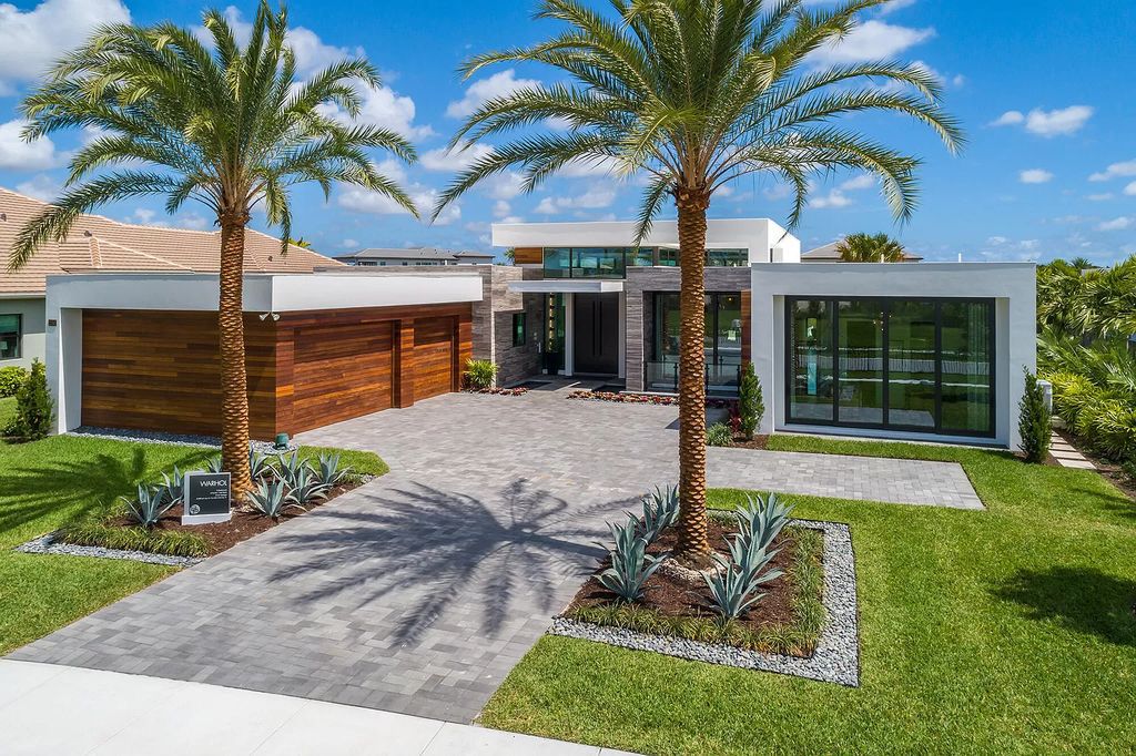 The Home in Boca Raton is a modern one story estate features a fabulous entertaining backyard with upgraded summer kitchen now available for sale. This home located at 17242 Brulee Breeze Way, Boca Raton, Florida