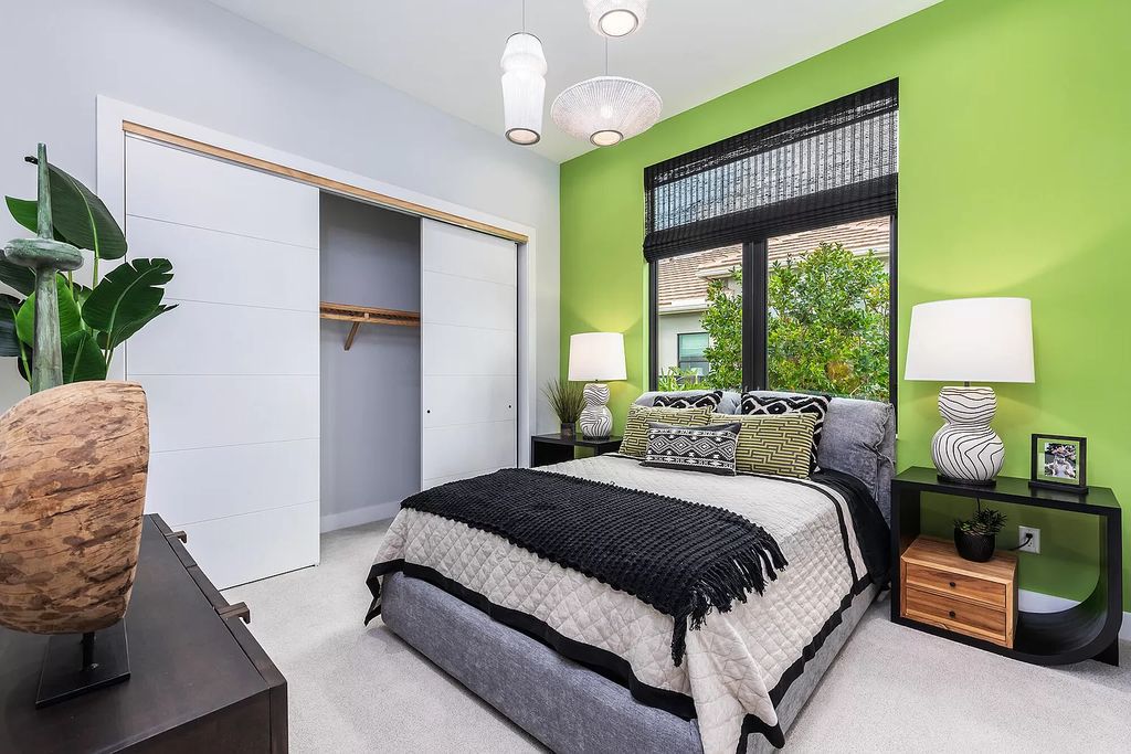 Illuminate your bedroom look. The appearance of lime green color used for the wall adjacent to the bed and the window has brightened the whole bedroom with the main color of black, white, and gray. A headboard and other neutral hues accessories balance and soften the bold accent wall.