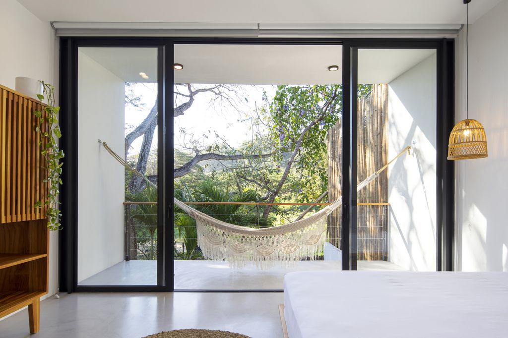 Naia House with teak roof, opens up Costa Rican rainforest by Studio Saxe