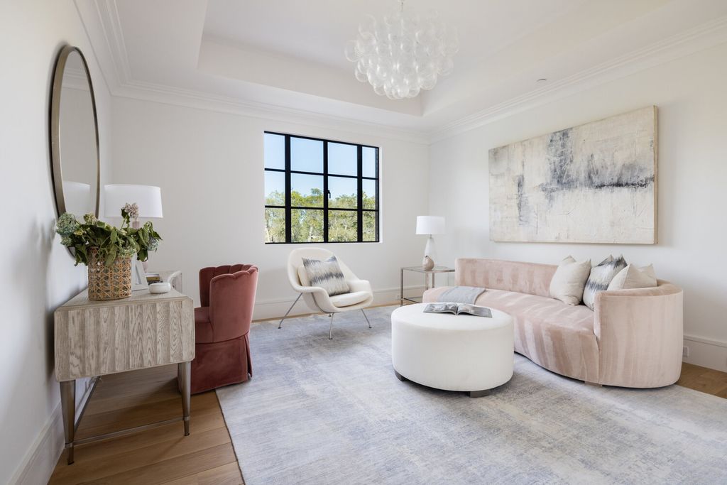 To be honest, the style of each object in your living room is inspired by the style of the others. The desk creates a secluded space, while the throw pillows link to the wall texture. In addition, the pastel pink curved sectional gives a more peaceful atmosphere. A soothing environment with gentle hues that may be mixed and matched.