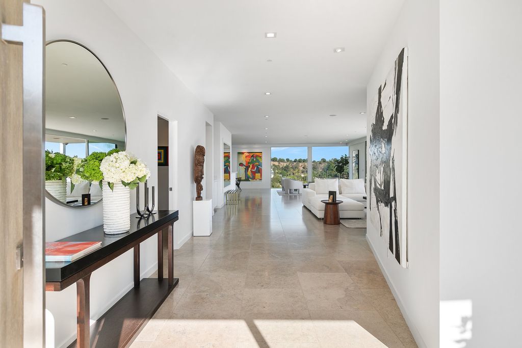 The Home in Beverly Hills is a totally remodeled and updated contemporary estate with head on city to ocean views now available for sale. This home located at 1476 Carla Rdg, Beverly Hills, California