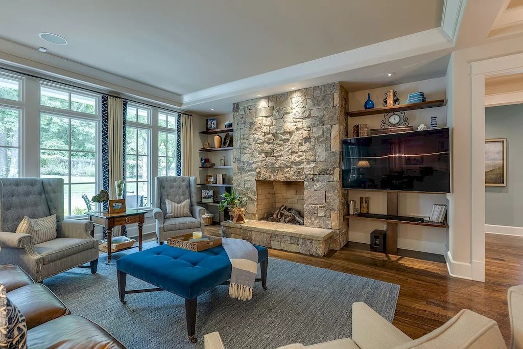 Living room with rustic style is raised to a new level by combining traditional rustic in the central stone fireplace with modern rustic in the interior decoration in blue tones. Moreover, the construction of wall shelves on both sides of the fireplace makes this rustic style room more prominent and saves a lot of space. 