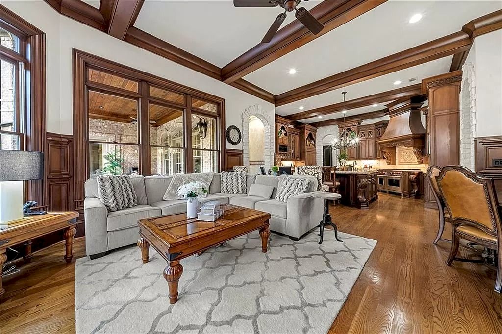 To bring additional vibrancy to a decorating plan, mix and match accent colored pieces of furniture. In this grey and black monochromatic living room, this classic couch in brilliant grey fabric gives an uplifting flash of color. The space with wooden architecture contributes to the room's natural ambience.