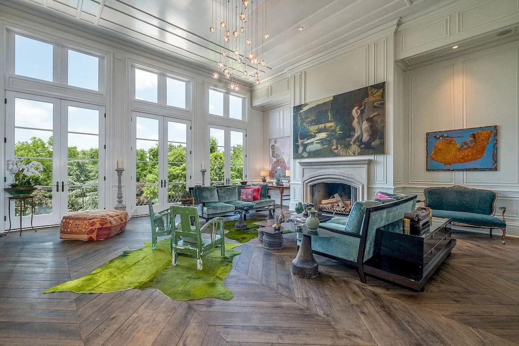 Instead of painting the entire house green for the traditional living room, the designer chose some furniture to be the focal point. A leafy green carpet and a few chairs are more than enough to add some color to this stark white space. Because of the velvet material used, a dark pistachio green sofa blends in with this warm space.