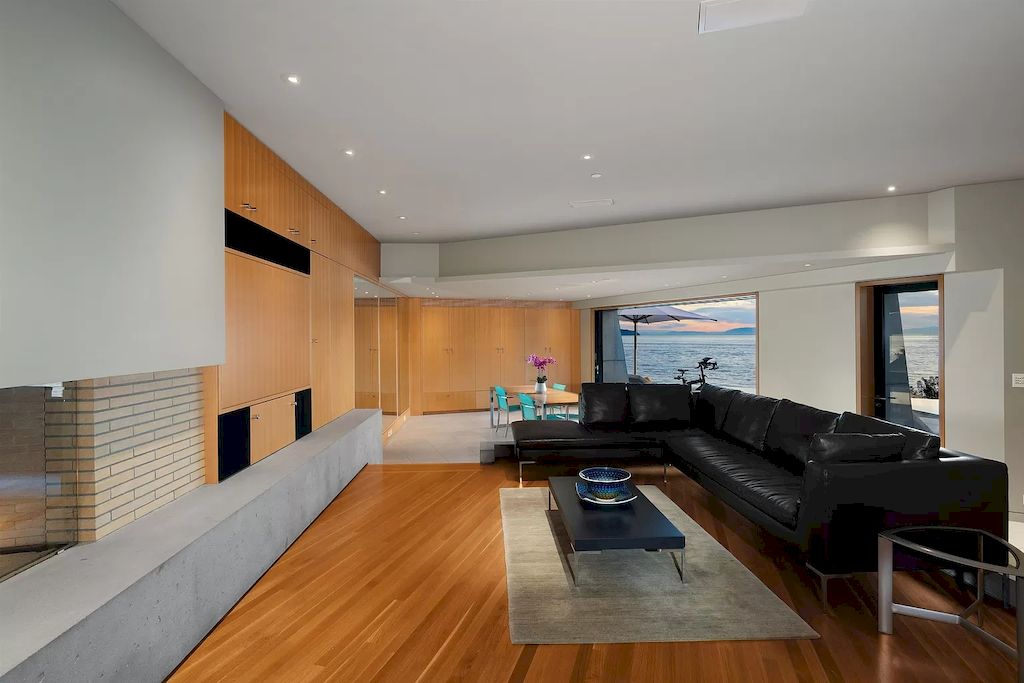 This design is for you if you like minimalist decor. To add variety and modernity, they used gray painted walls, more wood paneling, and a tiled fireplace. The minimalist living room design shines and blends well with the black leather couch.
