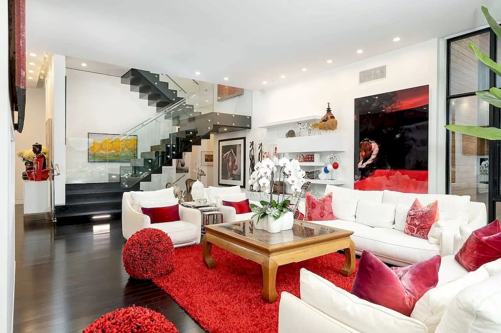 Don't know how to decorate and enhance an all-white room? Try using red for almost all of your living room decorations. As in the Red Living Room Ideas above, rose red and dark red are used for throw pillows; At the same time, cherry red is optional for stylized ottomans as well as faux fur rugs in a subtle way.