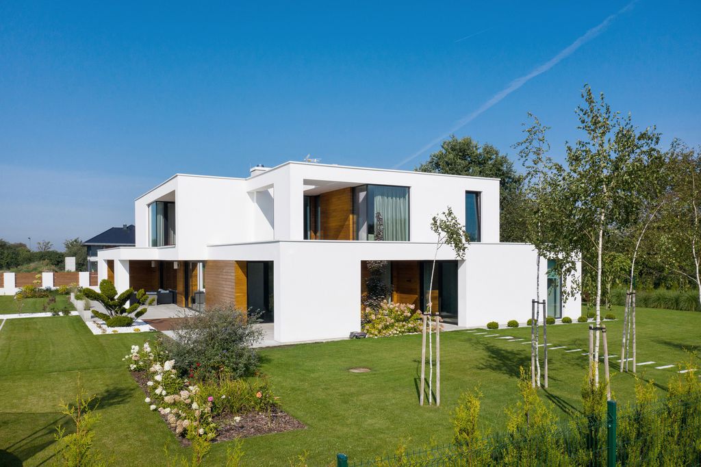 House with Niches, Combines Elegant White Blocks by RS + Robert Skitek