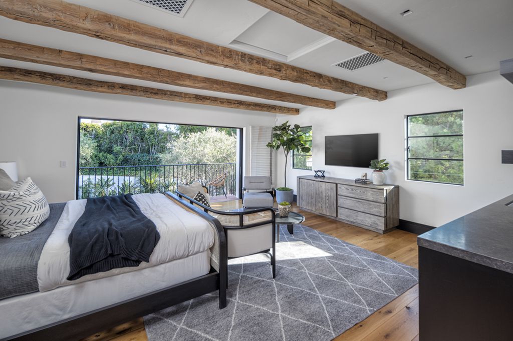 Bring the outdoors into your bedroom if you can't get enough of it! The glass wall and skylights in this greenhouse-themed bedroom bring in plenty of natural light. Add a selection of potted plants to finish the effect.