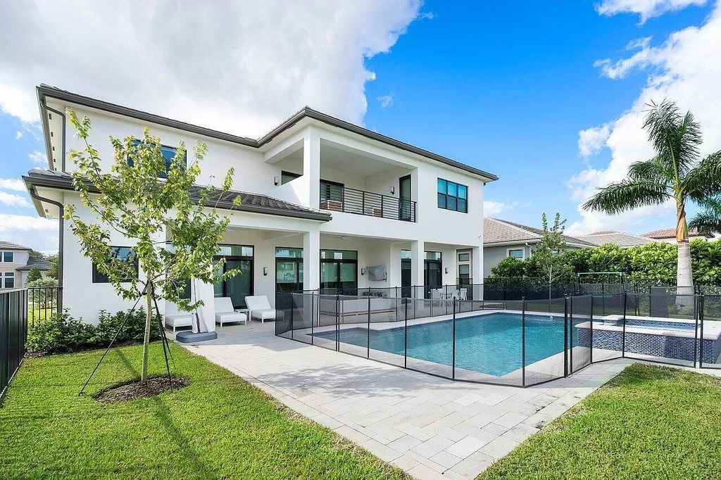 The Home in Boca Raton is a new transitional contemporary estate in the community of Boca Bridges with lake views now available for sale. This home located at 17413 Rosella Rd, Boca Raton, Florida